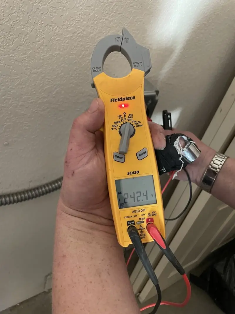 Voltage testing with clamp meter during Outlet Installation in Sierra Vista